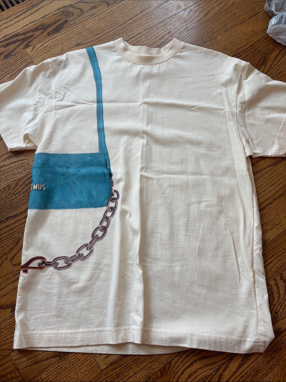 Jacquemus Cream Tee with Teal Bag Graphic